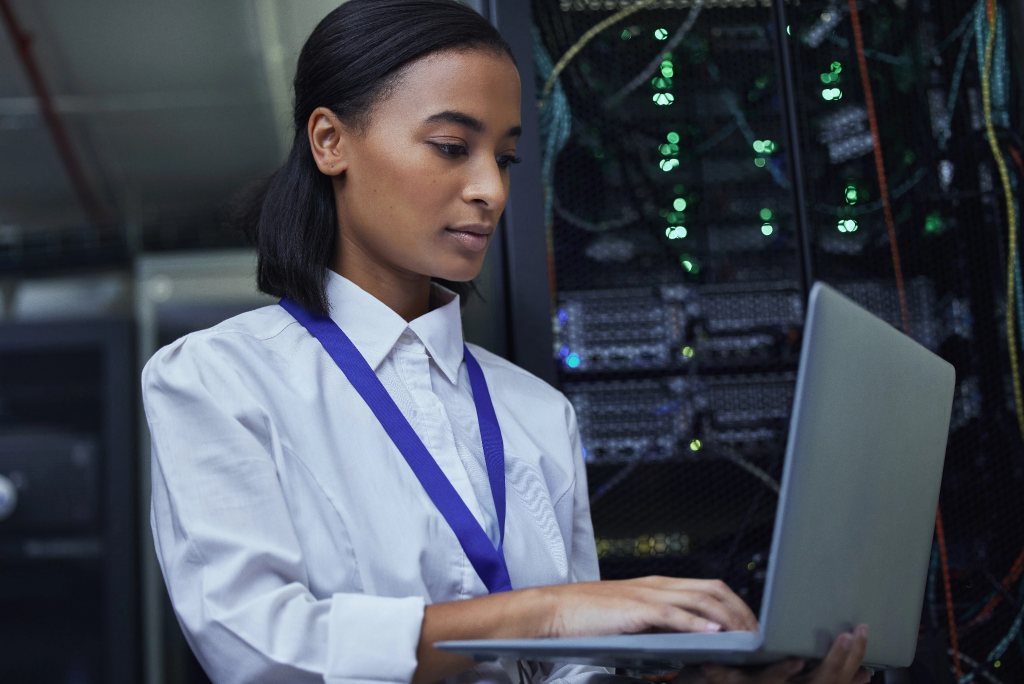 Checking the servers vitals. Cropped shot of an attractive female IT support agent working in a dark network server room