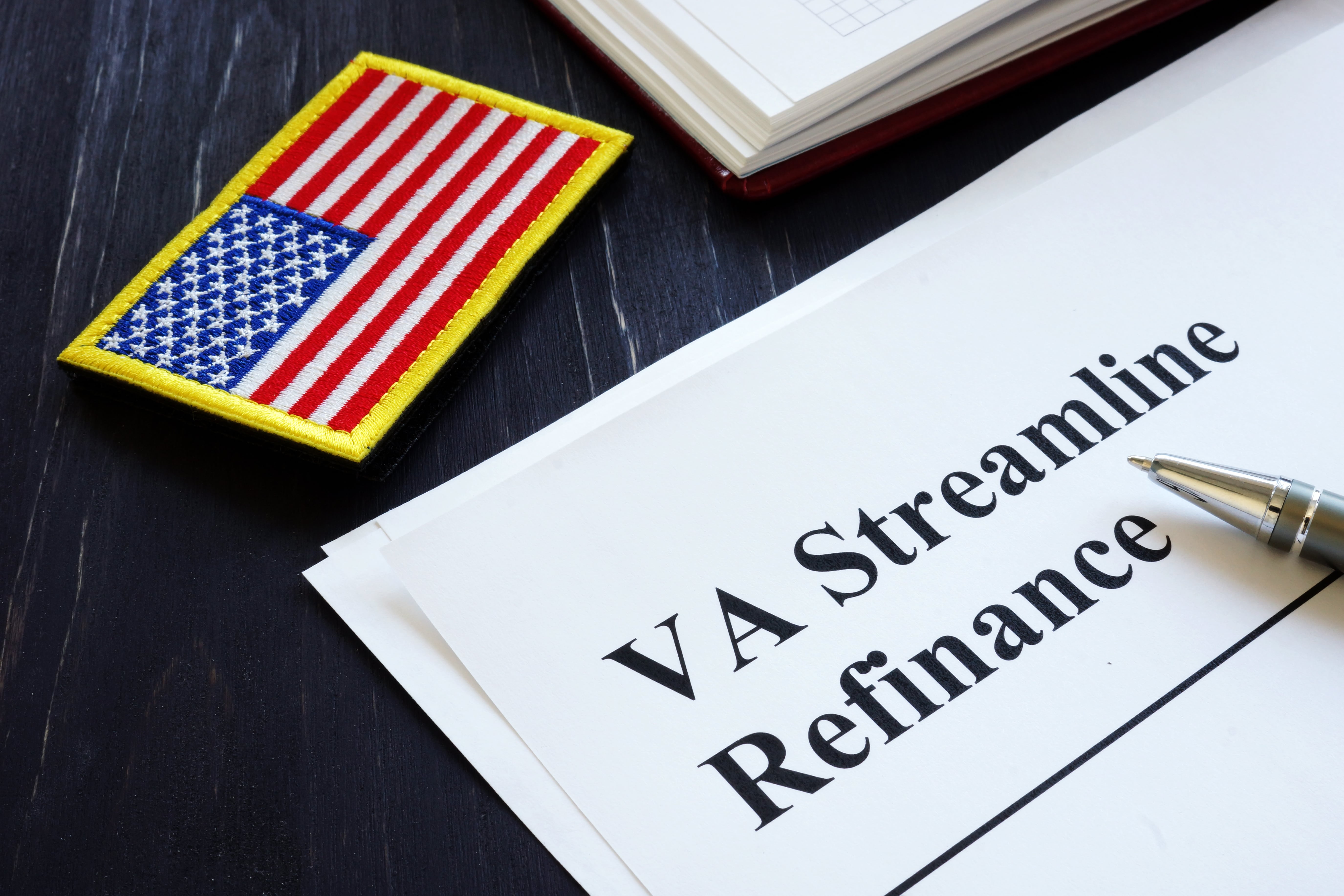 American flag on uniform badge and document that reads VA Streamline Refinance.